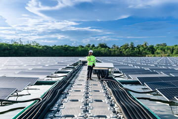 The portrait of a asian young engineer checks photovoltaic solar panels. Concept. renewable energy...