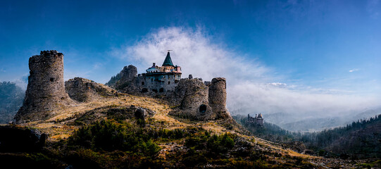 3D rendering. A lonely abandoned castle in the mountains with dramatic sky background
