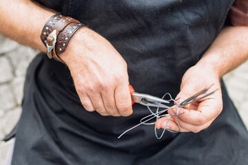 Tinker (Drotar) making a product from wire. Traditional folk art in Slovakia