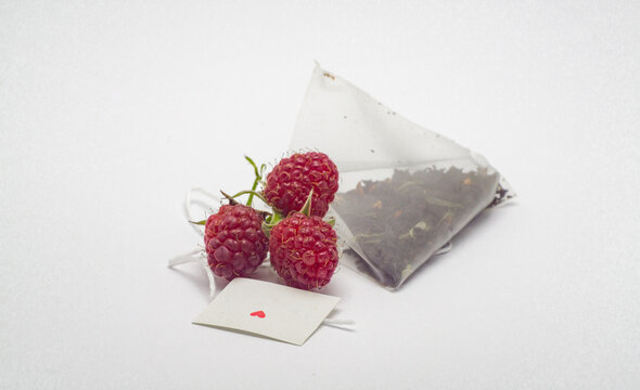 triangle fiter tea bag with fresh raspberry