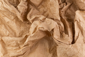 Background from crumpled craft paper. Abstract brown background.