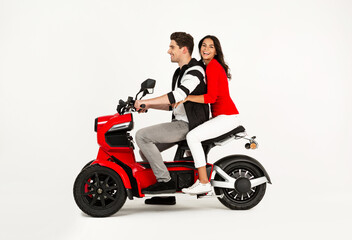 Fototapeta na wymiar young attractive couple riding an electric motorbike scooter happy having fun together