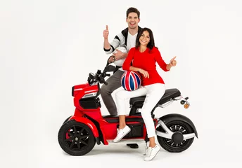Foto op Plexiglas young attractive couple riding an electric motorbike scooter happy having fun together © mary_markevich