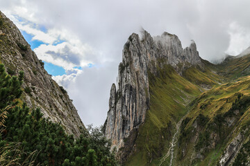 The famous Swiss Alps peak Saxer Lucke with stunning rock formation in rising mist and fog