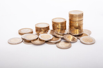  Close-up of coins stack on white background. 
