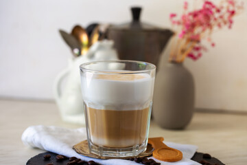 Glass of hot latte macchiato coffee, natural light, selective focus. Close  up.