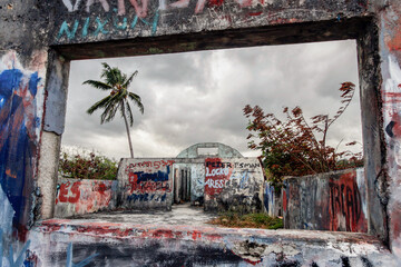 Abandoned American army quonset hut, concrete structure remaining and graffiti - obrazy, fototapety, plakaty