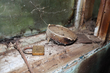 Old vintage lock on the window frame, abandoned house, scary Halloween image