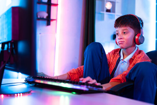bored sleepy Young teenager kid while playing online video game on computer at home - concept of laziness, sleepless and loneliness.