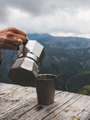 hand holding a coffee pot