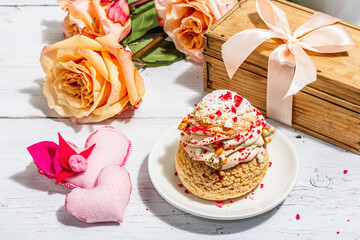 The concept of romantic gift. French Shu cake, hibiscus tea, bouquet of roses, festive decor