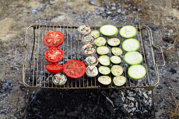 Vegetables on a camp fire barbecue while camping outdoors