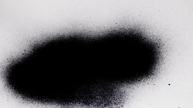 Black spray paint on a white background. Overlay.
