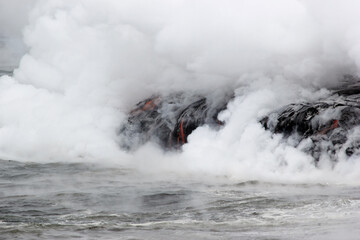 Fototapeta na wymiar The lava glow of magma flowing in the ocean, Volcanic National Park Hawaii