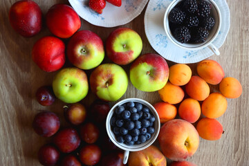 Various healthy seasonal food arranged on wooden background. Flat lay.