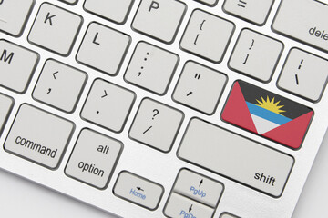 national flag of antigua and barbuda on the keyboard on a grey background .3d illustration