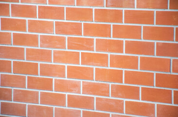 Red brick wall with sunlight pouring down