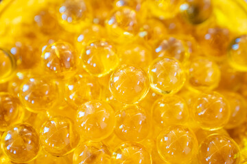 Clear transparence round glass acrylic plastic bubbles with light reflex inside in a yellow gold plate.