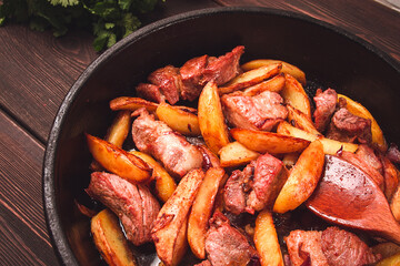 Ojakhuri, Traditional Georgian dish, fried potatoes with meat, in a clay frying pan, top view, no people, homemade,
