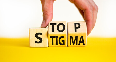 Stop stigma symbol. Concept words Stop stigma on wooden cubes. Businessman hand. Beautiful yellow table white background. Business and Stop stigma concept. Copy space.