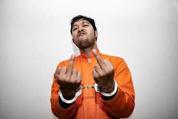 Prisoner in orange robe concept,Portrait of asian handsome man in Prison uniforms,Bandit has a lot...