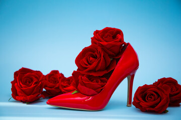 Red shoes woman. Fashion photo. Beauty. Shoes. red roses. Valentine day 