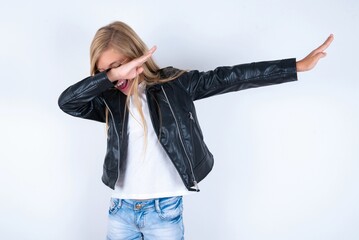 Photo of funky beautiful caucasian blonde little girl wearing biker jacket and glasses over white...