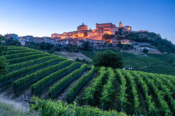 Fototapeta na wymiar La Morra village illuminated in the evening. Langhe region of Piedmont, Cuneo, northern Italy. 