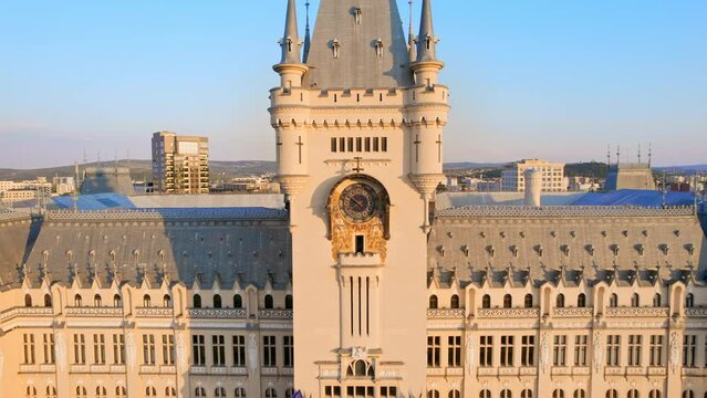 Aerial drone view of the Palace of Culture in Iasi downtown at sunset, Romania. Square with Stephen the Great statue, people and greenery in front of it, buildings around
