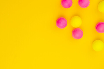 Abstract colored balls background. Multi-colored taw toy scattered on bright paper. Base for design nice backdrop, wallpaper, poster. Noisy surface texture
