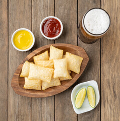 Pastel, typical brazilian finger food over wooden table