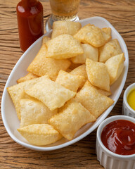 Pastel, typical brazilian finger food over wooden table