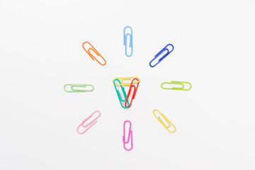 Top view colorful paper clips isolated on white background. High key photography.