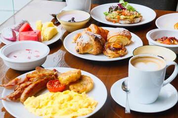 Breakfast in cafe - table full of fresh food with avocado toast