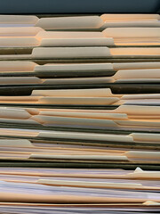 View of file folders with documents in filing cabinet.