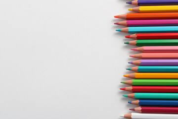 Set of colored pencils on white background. Pencils of various colors lined up on a top angle.
