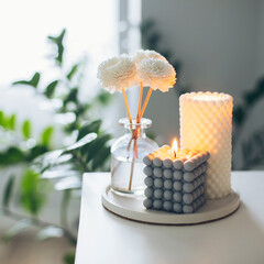 Two trendy burning candles and aroma fragrance diffuser on table. Home aroma. Wellness. Banner image for design