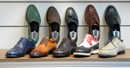 casual classic men's shoes in different colors and models on the stand