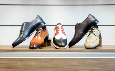 casual classic men's shoes in different colors and models on the stand
