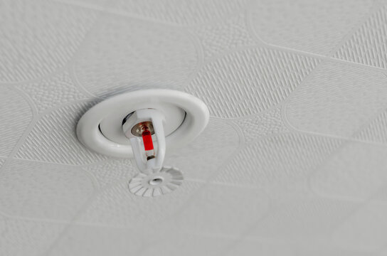 Fire fighting equipment, sprinkler on white ceiling background. Fire fighter safety concept.