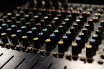 Fototapeta premium Mixer control. Music engineer. Backstage controls on an audio mixer, Sound mixer. Professional audio mixing console with lights, buttons, faders and sliders. sound check for concert.