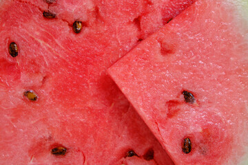 Background red watermelon pulp with black seeds.