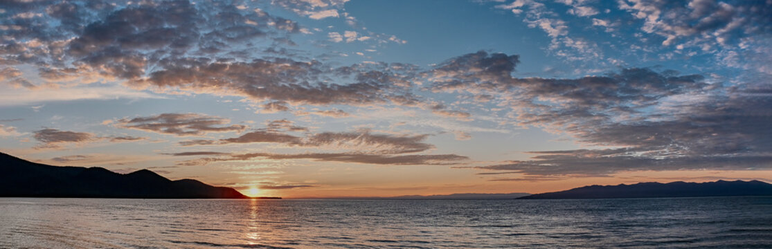 Barguzinsky Bay of Lake Baikal, Russia. Colorful sunset. Scenic clouds on sky.