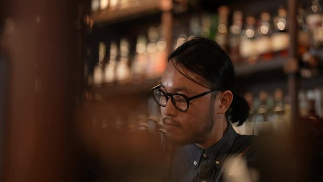 Night club concept of 4k Resolution. A bartender is making drinks for customers in a restaurant. A group of specialized clubs that sell alcoholic beverages.