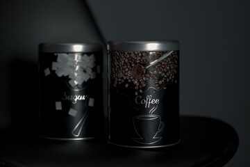 Jar of coffee with jar of sugar next to it on a black background