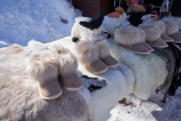 Warm slippers with fur are sold at the street market