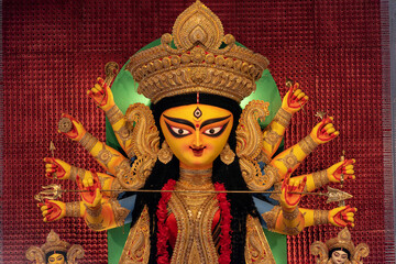 Idol of Goddess Devi Durga at a decorated puja pandal in Kolkata, West Bengal, India. Durga Puja is...