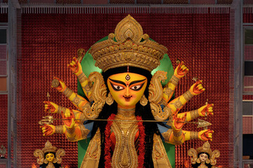 Idol of Goddess Devi Durga at a decorated puja pandal in Kolkata, West Bengal, India. Durga Puja is...