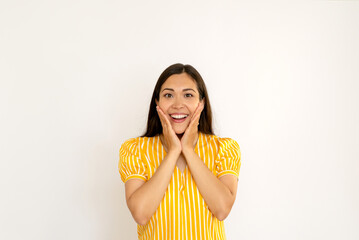 attractive young brunette woman in yellow shirt smiling on white background copy space. happy positive brunette. holiday, surprise concept