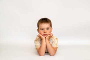 portrait of a little boy on a white background copy space. sad child